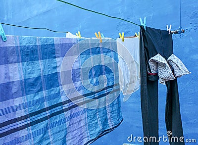 This is a picture of a clothesline with clothes dried on it Stock Photo