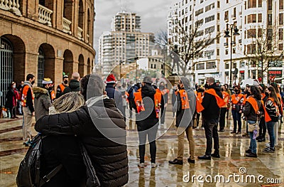 Couple Hugging from Behind listening a Christmas Concert on the Street Editorial Stock Photo