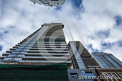 Cranes and building device on a construction site of a skyscraper in downtown Toronto, surrounded by other high rise towers Stock Photo