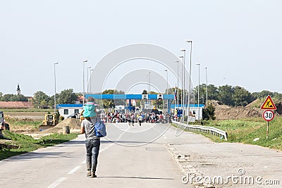 Refugees gathering in front of the Serbia-Croatia border crossing of Sid Tovarnik on the Balkans Route, during the Refugee Crisis Editorial Stock Photo