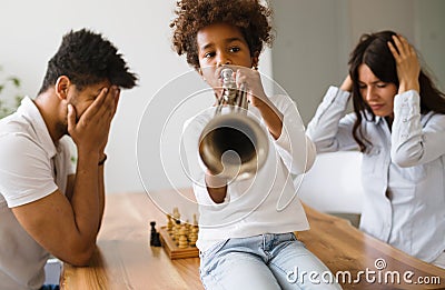 Picture of child making noise by playing trumpet Stock Photo