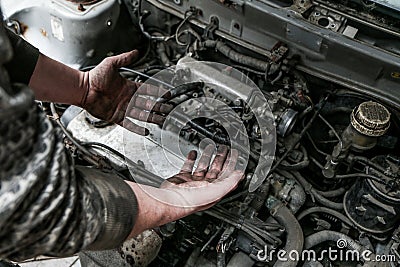 Picture of dirty hands of a guy above the engine Stock Photo