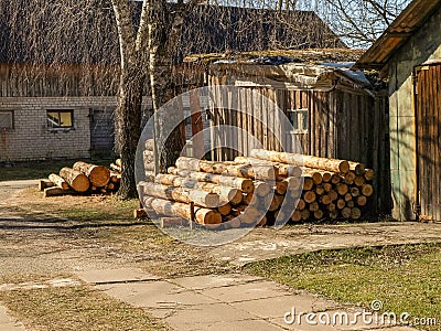 Picture with a farm barn and prepared firewood for the winter Stock Photo