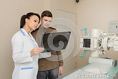 Picture of a female doctor explaining the spinal x-ray Stock Photo