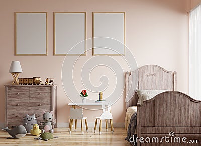 Picture frame on a cream colored wall in a children`s room with a bed by the window, decorated with dolls and toys on the wooden Stock Photo