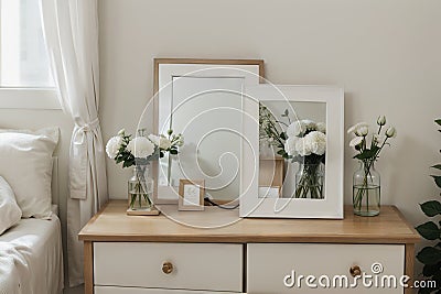 Picture frame and flowers on a dresser in a contemporary bedroom. (Picture in frame is mine.) Stock Photo