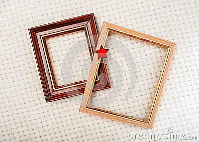 Picture frames with gilding and red star close-up on white woolen plaid background Stock Photo