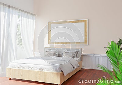 Picture frames are hung on the bedroom walls light shines through large glass doors and curtains. overlooking trees outside give a Stock Photo