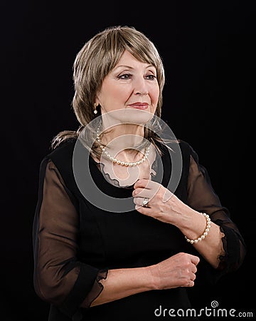 Picture of gorgeous older woman posing with imitation pearl set Stock Photo