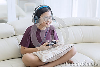 Happy teen boy playing video games with a joystick Stock Photo