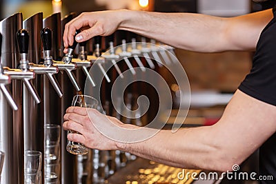 Innkeeper draws a beer at a beer pump Stock Photo