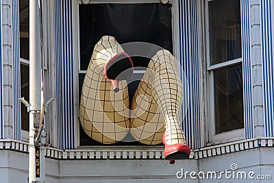 Legs with nylons sticking out of a window in San Francisco California Editorial Stock Photo