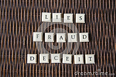 Letter blocks spelling out the words fraud deceit and lies Stock Photo