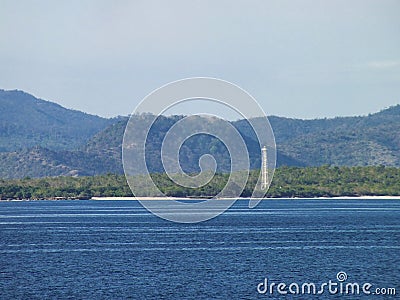 Picture of a lighthouse with mountains in the background stock image Stock Photo