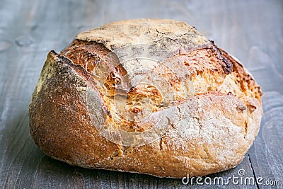 Loafs or miche of French sourdough, called as well as Pain de campagne, on display on a wooden table. Stock Photo