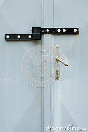 Picture of locked hasp on grey metal gate - Image. Front view on locked garage gate Stock Photo