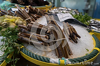 Razor shells on ice in a fish shop. Delicious razor fishes in a mediterranean food market Stock Photo