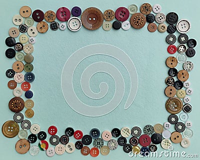 Image of multicolored button frame on soft cyan colored background. Stock Photo
