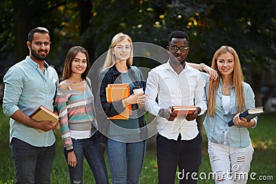 Picture of multiethnic group of graduates students standing outdoors. Stock Photo