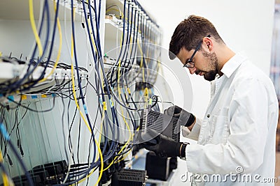 Picture of network technician testing modems in factory Stock Photo