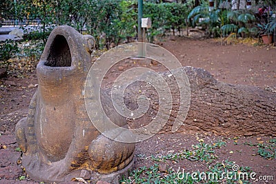 Stock photo of a old dirty open mouthed frog dustbin kept in the public park or garden. Picture captured under natural light at K Stock Photo