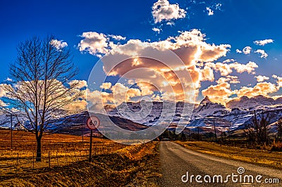 Picture perfect snow capped Drakensberg escarpment mountains and green plains in Underberg near Sani pass South Africa Stock Photo