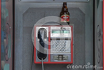 Picture of a phone booth in the Serbian capital with a beer bottle left on the top of it, after a night of heavy binge drinking Editorial Stock Photo