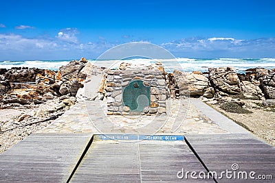 The plate marking the point of Cape Agulhas, the southernmost point of africa. The indian ocean is on the right, the Atlantic Stock Photo