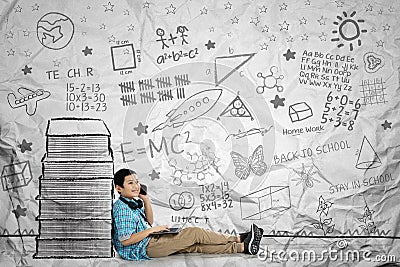 Preteen schoolboy with smartphone near books Stock Photo