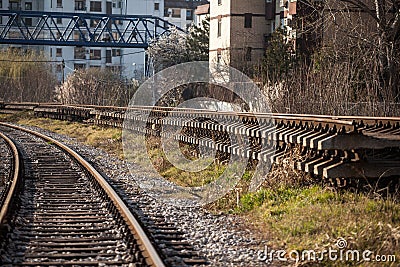 Selective blur on a railroad track in curve with new rails with concrete sleepers ready for replacing the old railway line Stock Photo