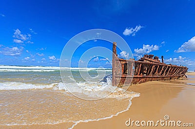 Picture of a rusted shipwreck at Seventy Five Mile Beach on Frazer Island in Australia Stock Photo