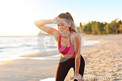 Woman running alone at beautiful dusk on the beach Stock Photo