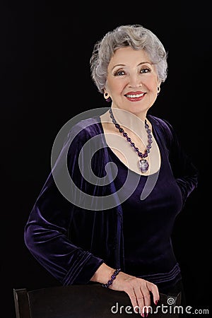 Picture of spectacular older woman posing with amethyst jewelry Stock Photo