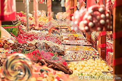 Candies, mainly gummy sweets and lollilpops, diversified, display in loose in a candy shop during a carnival or a fair Stock Photo