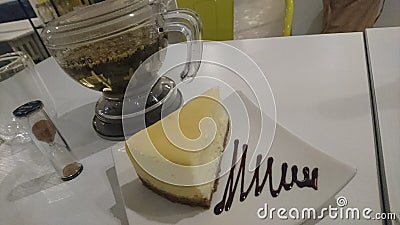 Enjoying a nice piece cheesecake with herbal tea Stock Photo