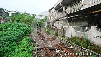 A railway surrounds the houses Stock Photo