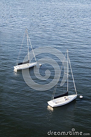 Two sailboats floating in a harbor in Boston, Massachusetts Stock Photo