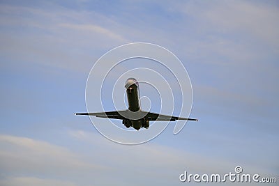 Incoming propeller passenger jet airplane with cloudy sky Stock Photo