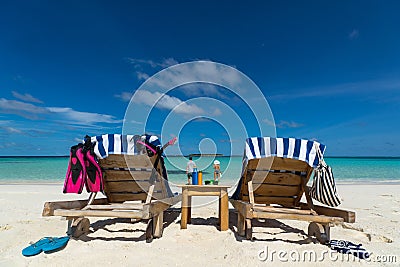 Picture of wooden beach chairs on the tropical beach, vacation. Stock Photo