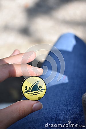 A yellow bottlecap in the summertime Stock Photo