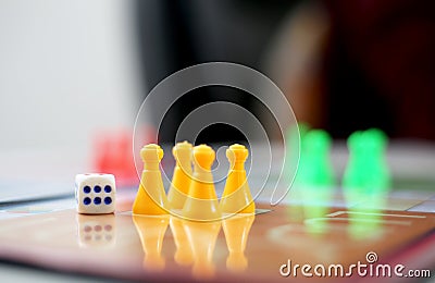 Picture of yellow ludo tokens and dice Editorial Stock Photo