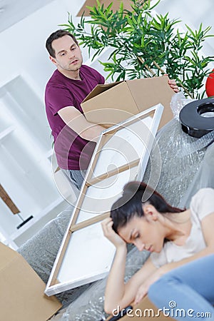 Picture young pair tired packing their things Stock Photo