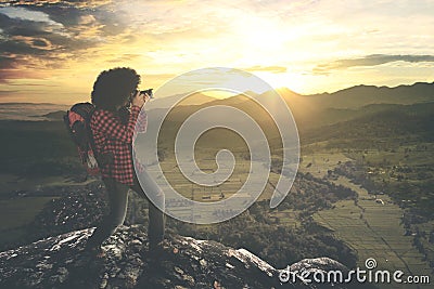 Young photographer takes a sunset photo Stock Photo