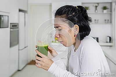 Nauseous woman drinking healthy juice Stock Photo