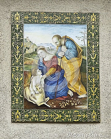 Art piece featuring Mary, Joseph, Jesus and a lamb in an outside wall niche on a street in Assisi, Italyy. Editorial Stock Photo