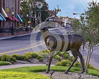 Bronze buck standing alertly, part of `A Wilderness Welcome` by Archie Saint Clair in the historic district of Grapevine Editorial Stock Photo