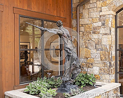 Bronze sculpture of a cowboy outside an art store in Vail, Colorado. Editorial Stock Photo