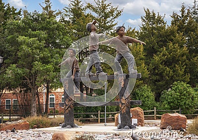 `Balancing Act`, a bronze sculpture from the Randolph Rose Collection purchased for this traffic circle by the City of Colleyville Editorial Stock Photo