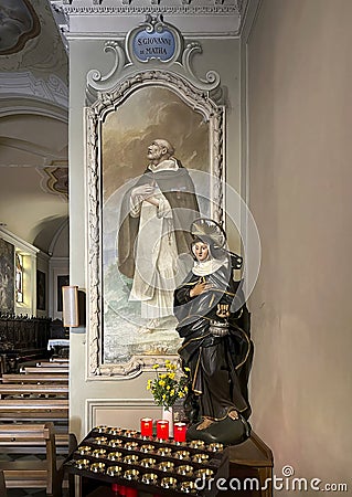 Carved wooden polychrome statue of Saint Martha in the Church of Saint Martha in Menaggio on Lake Como. Editorial Stock Photo