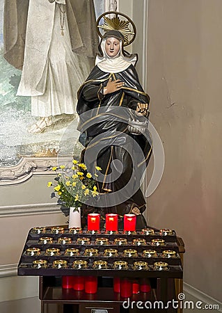 Carved wooden polychrome statue of Saint Martha in the Church of Saint Martha in Menaggio on Lake Como. Editorial Stock Photo